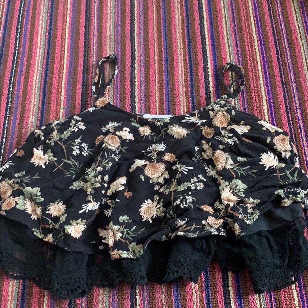 black spaghetti strap crop top with a flower print